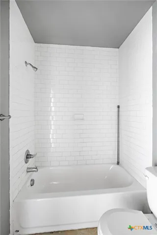 a bathroom with a bathtub and shower