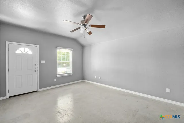 a view of an empty room with a window