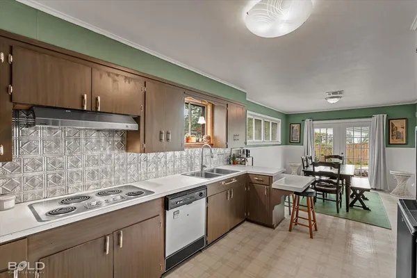 a kitchen with a sink stove and cabinets