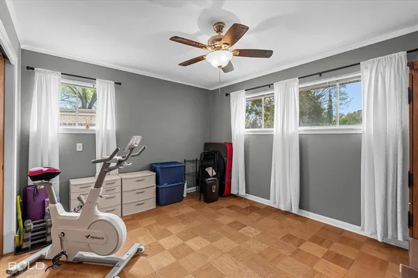 a workspace with furniture ceiling fan and window