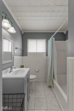 a bathroom with a sink a toilet and bathtub