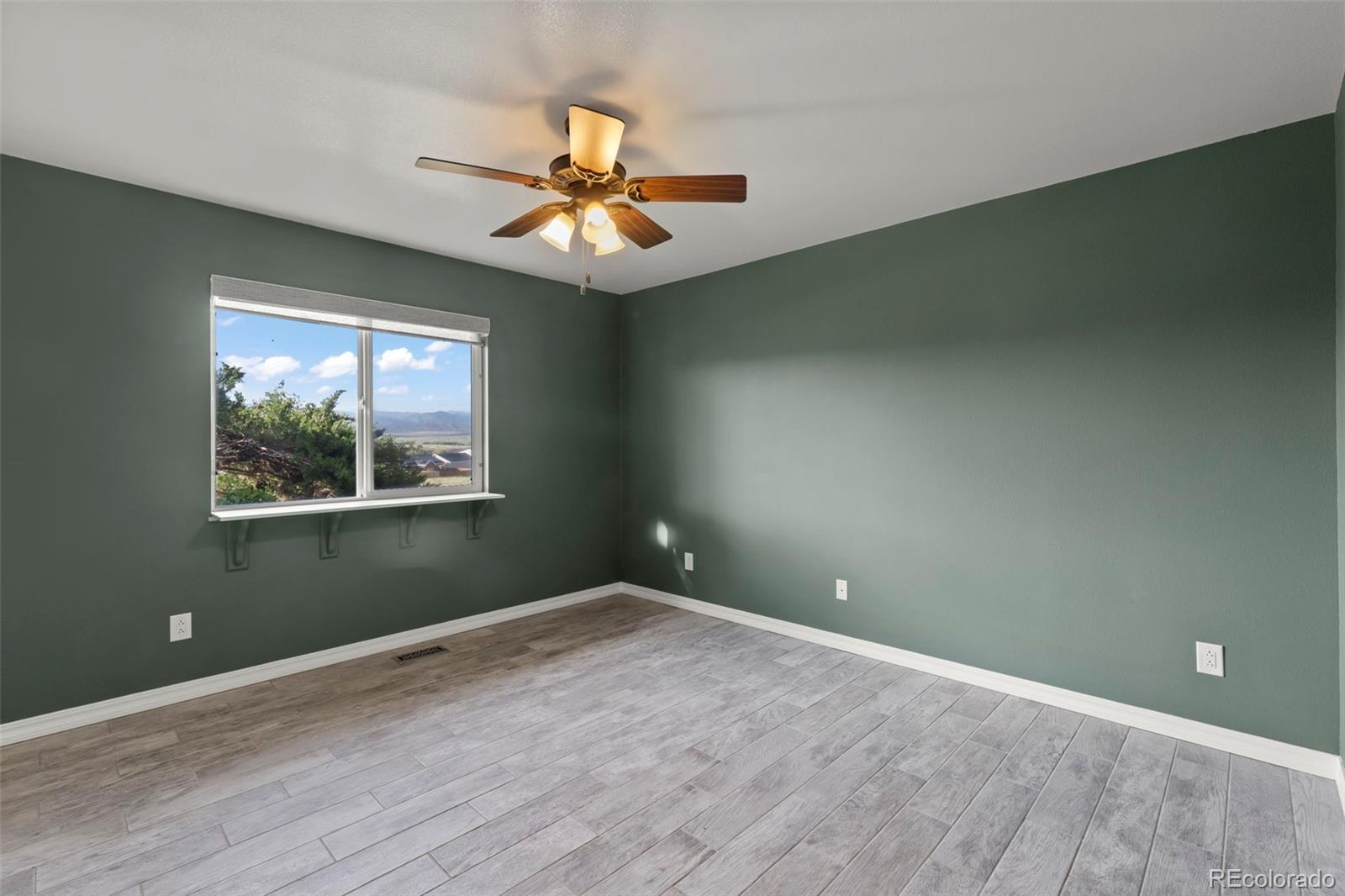 154 High Meadows Drive Florence, CO 81226 - Photo 15 of 27 an empty room with a window and a fan
