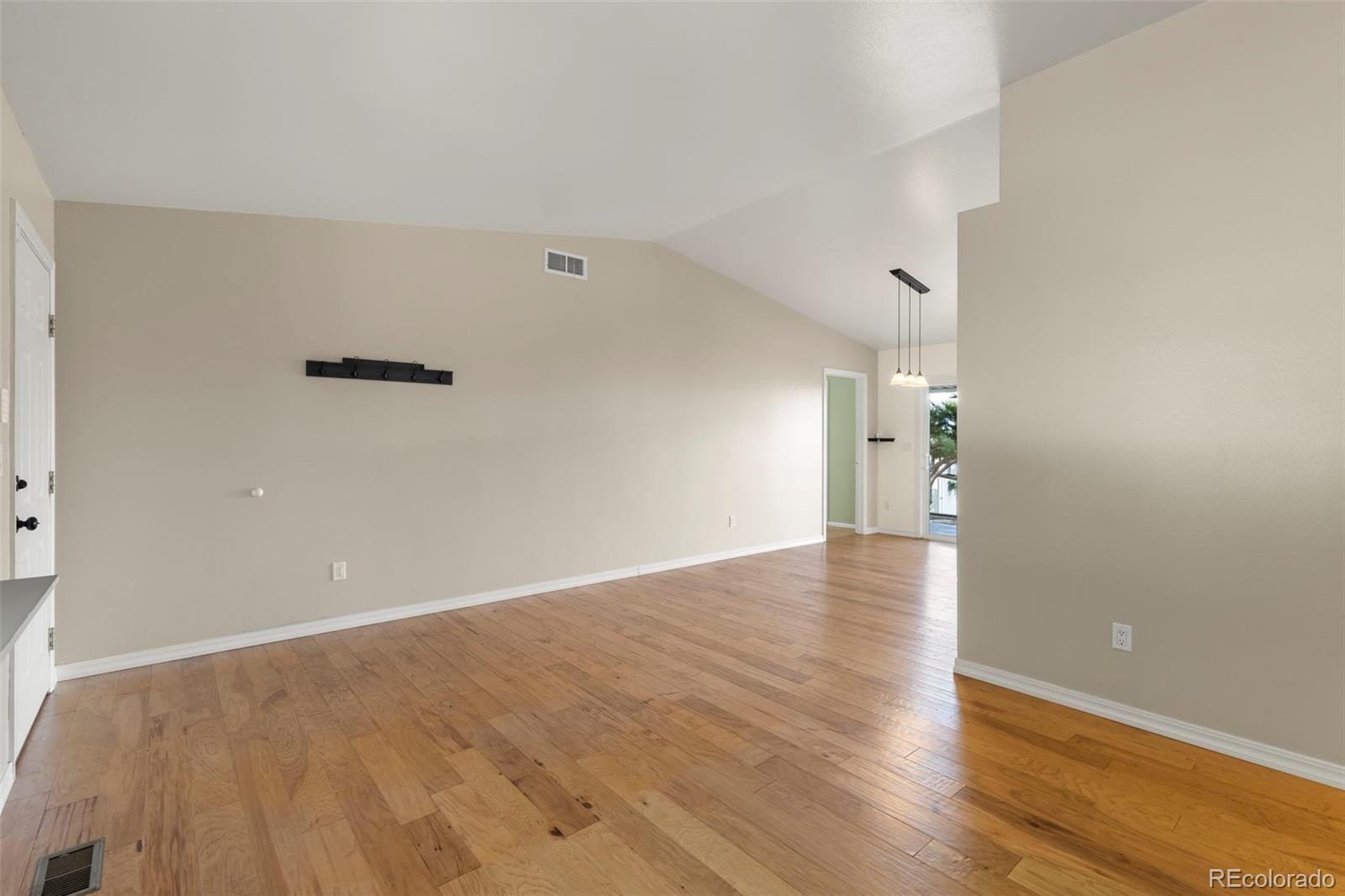 154 High Meadows Drive Florence, CO 81226 - Photo 3 of 27 a view of empty room with wooden floor