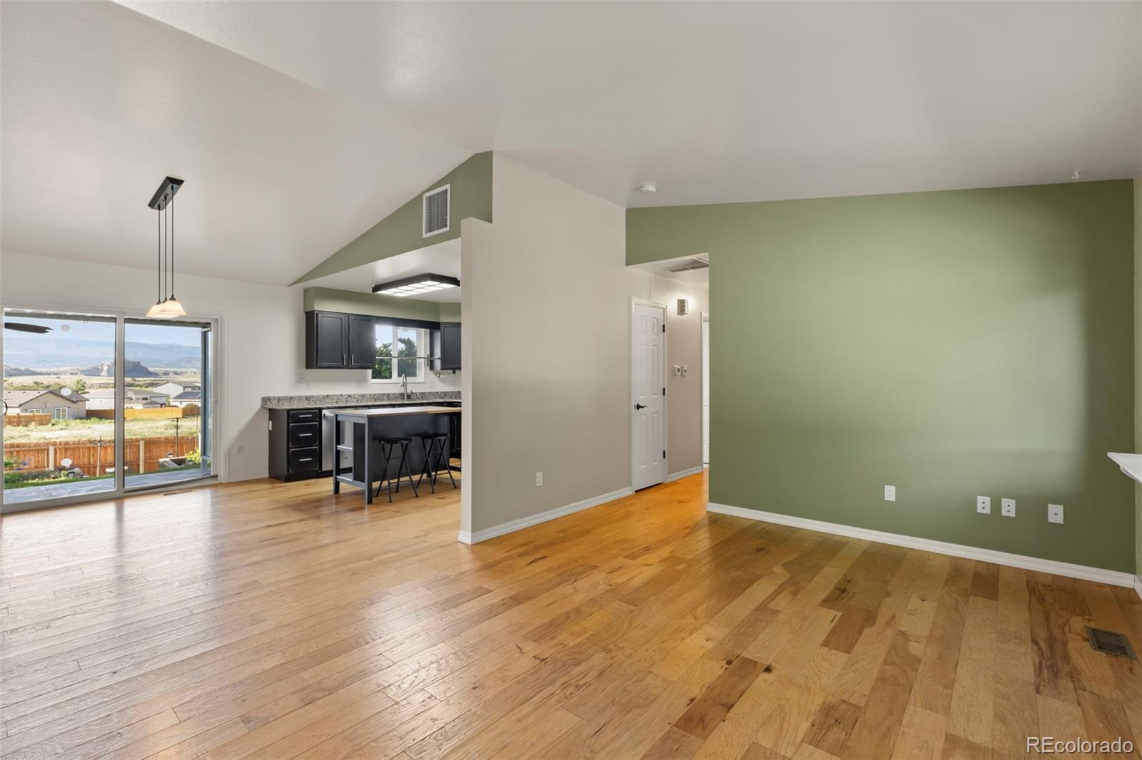 154 High Meadows Drive Florence, CO 81226 - Photo 4 of 27 a view of a kitchen with furniture and wooden floor