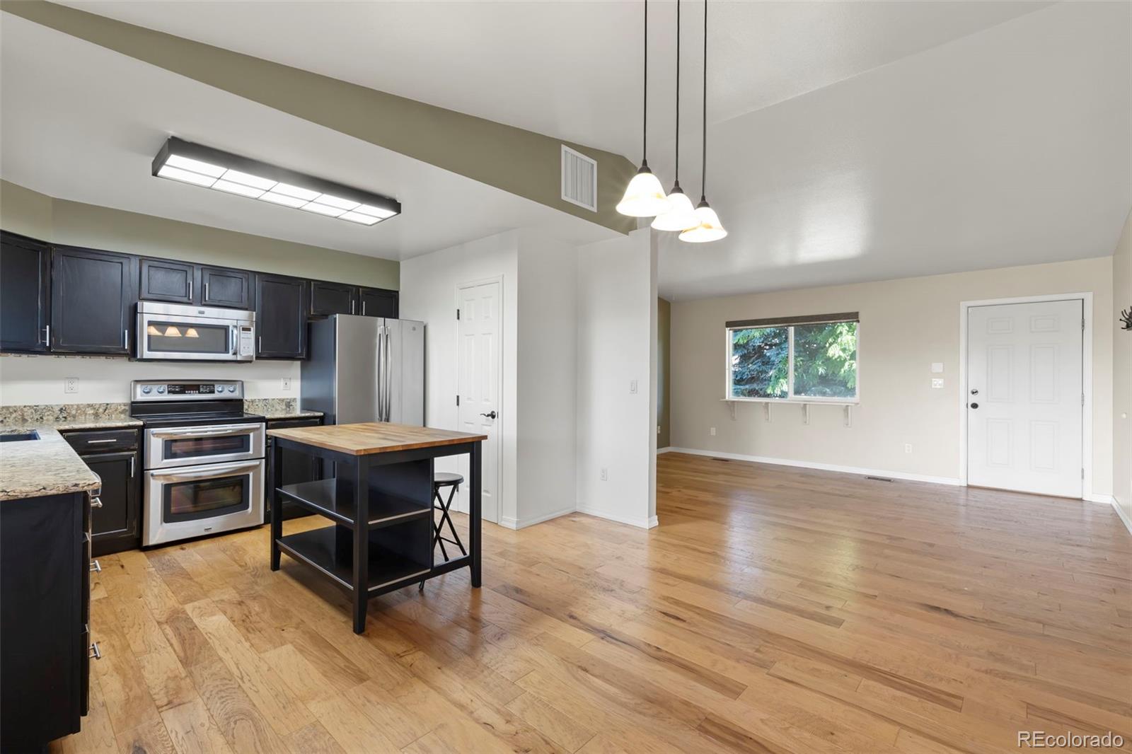 154 High Meadows Drive Florence, CO 81226 - Photo 6 of 27 a kitchen with stainless steel appliances a stove a refrigerator and a sink