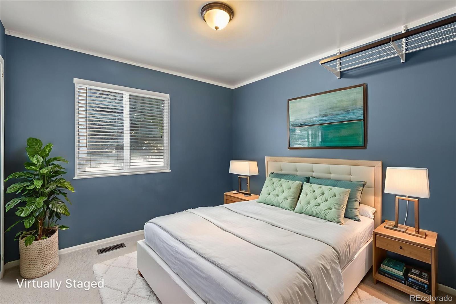 154 High Meadows Drive Florence, CO 81226 - Photo 10 of 27 a bedroom with a bed and a potted plant