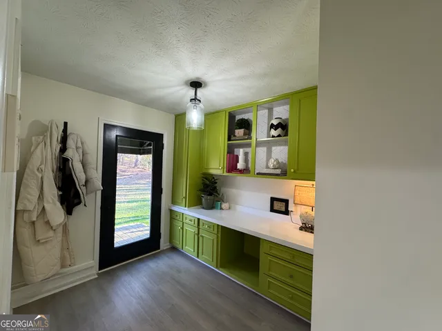 a view of kitchen with kitchen island wooden floor and window