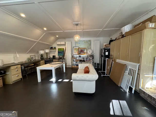 a living room with lots of furniture and kitchen view