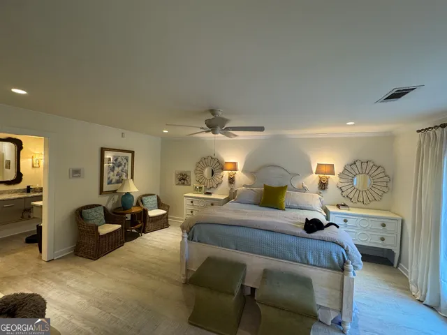 a bedroom with furniture and a chandelier