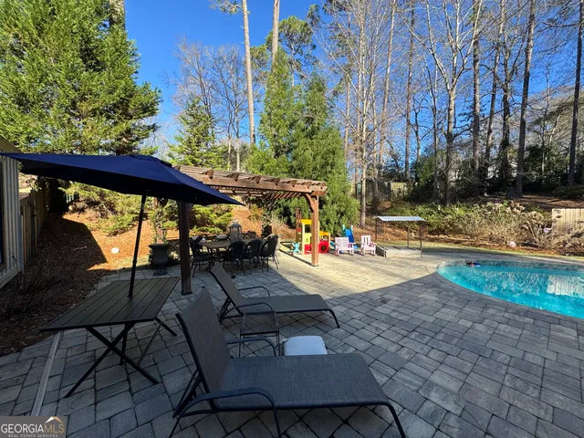 a view of a swimming pool with a patio
