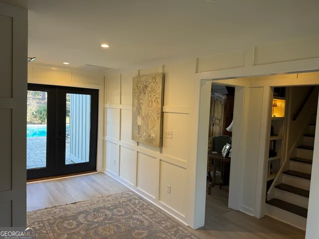 a view of a hallway with wooden floor and closet