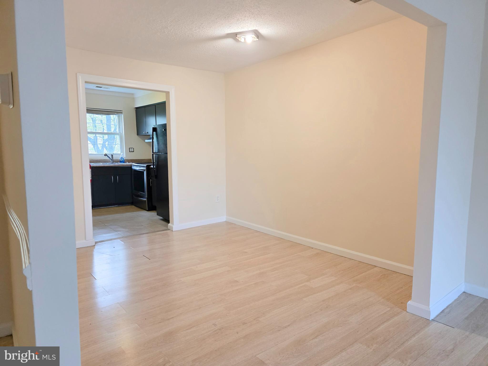 1294 Cooper Street, Unit A11 Beverly, NJ 08010 - Photo 3 of 10 a view of an empty room with a kitchen