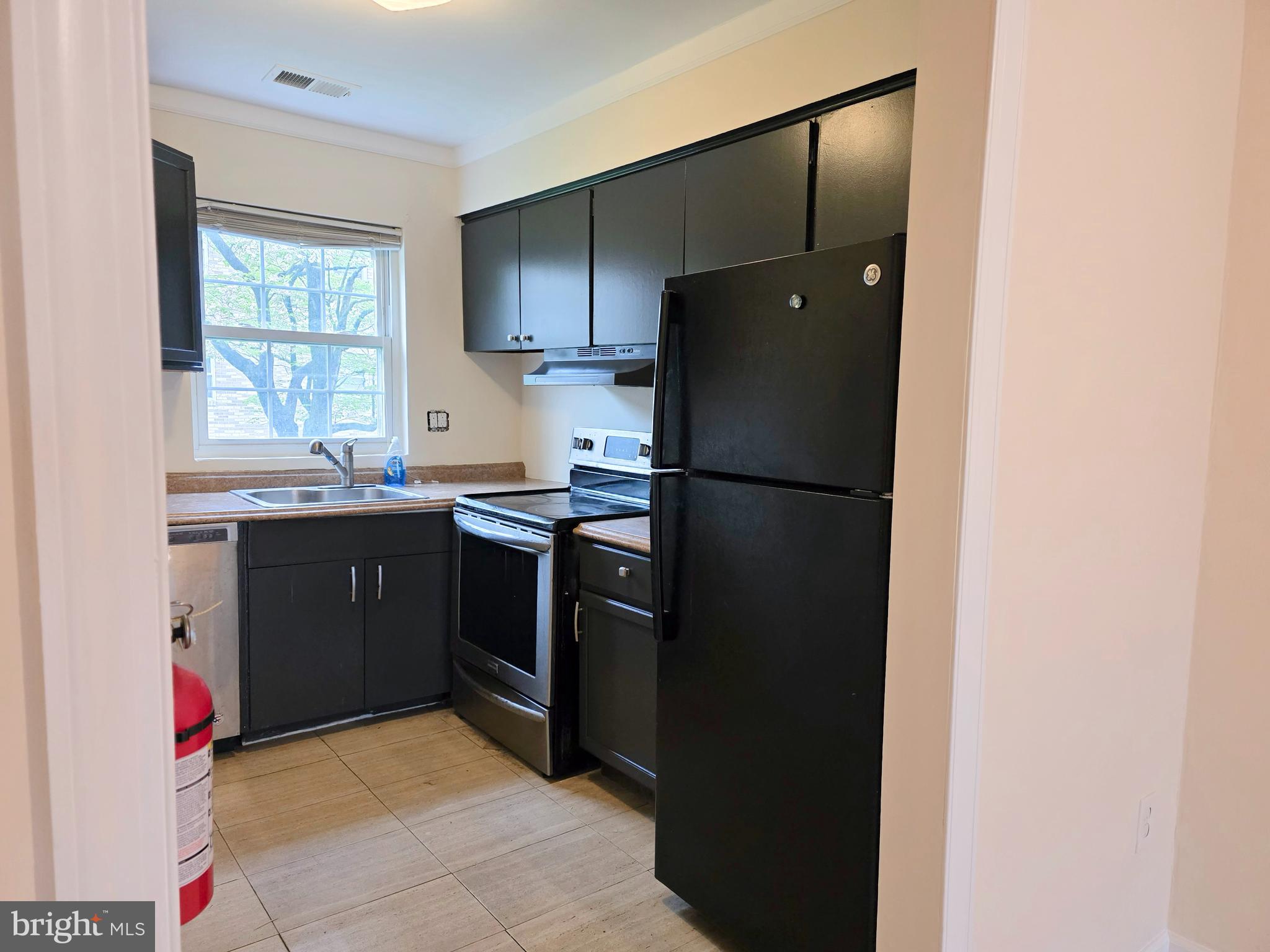 1294 Cooper Street, Unit A11 Beverly, NJ 08010 - Photo 5 of 10 a kitchen with a sink a refrigerator and window