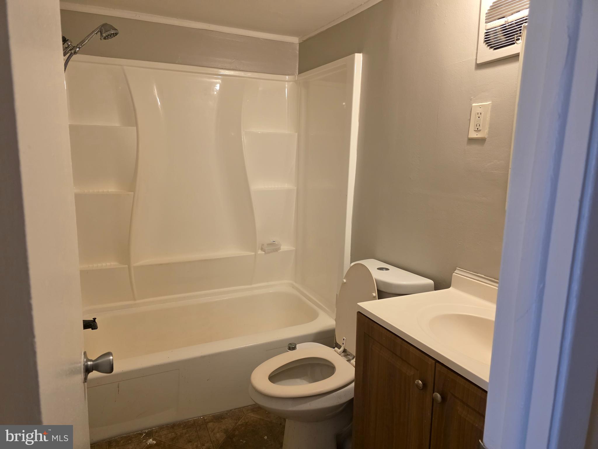 1294 Cooper Street, Unit A11 Beverly, NJ 08010 - Photo 9 of 10 a bathroom with a sink a toilet and shower