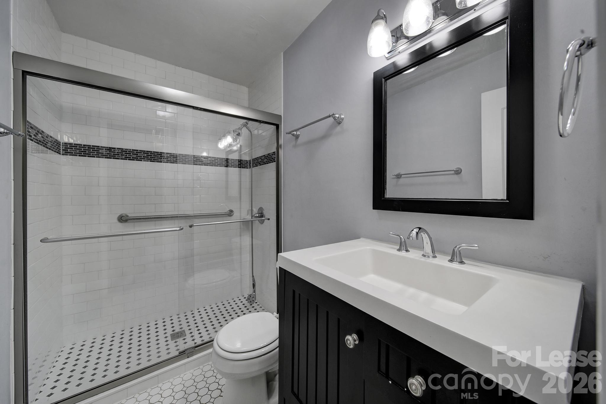 424 Main Street Matthews, NC 28105 - Photo 14 of 18 a bathroom with a sink toilet double vanity and shower