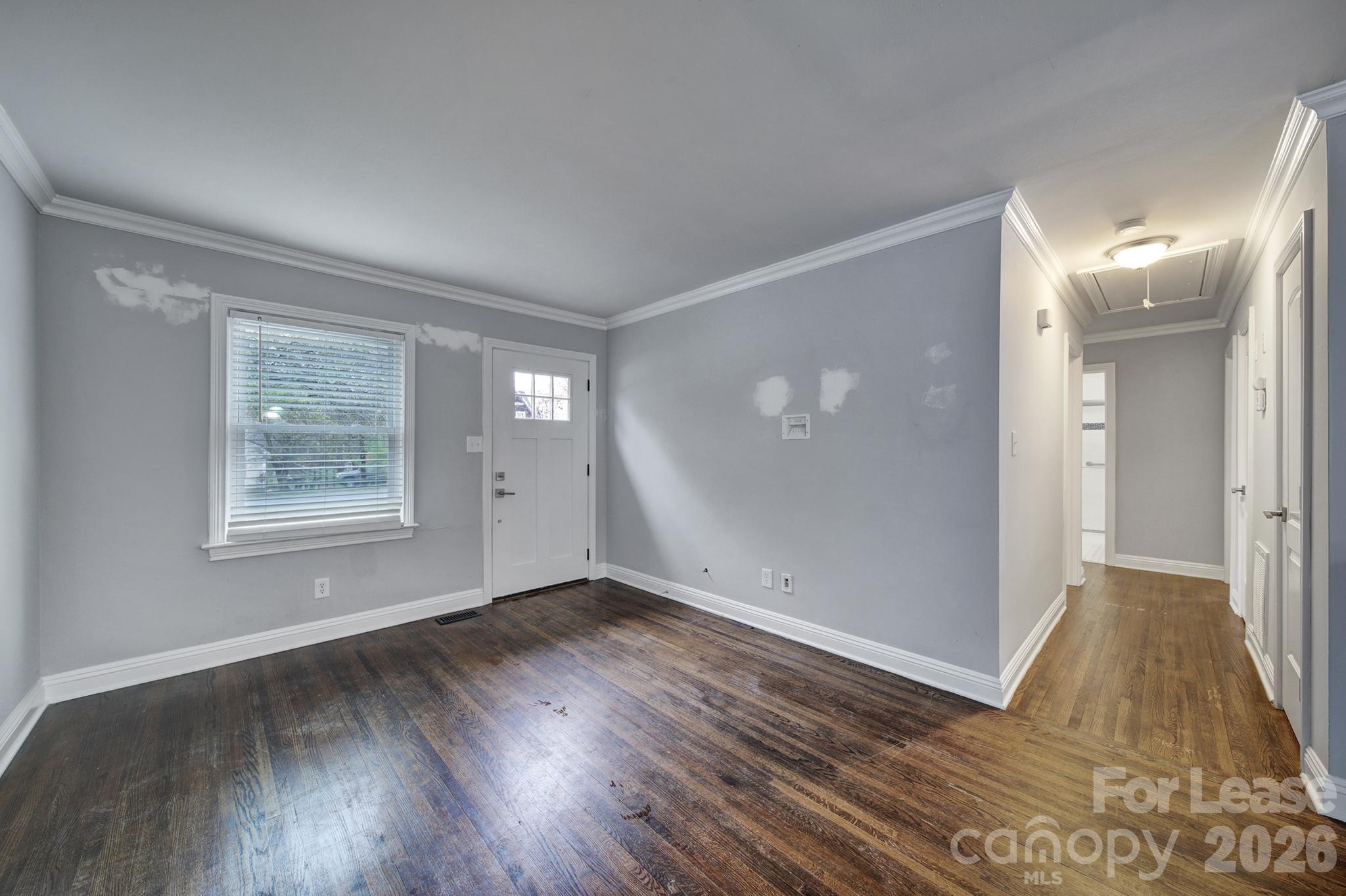 424 Main Street Matthews, NC 28105 - Photo 3 of 18 a view of an empty room with wooden floor and a window