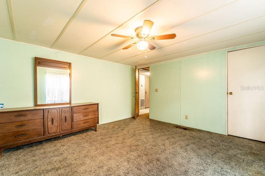 24031 Armadillo Road Astor, FL 32102 - Photo 35 of 43 a view of an empty room with window cabinet and chandelier