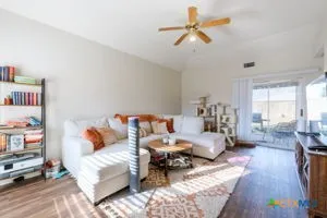 a bed room with furniture and a book shelf