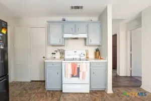 a kitchen with a stove top oven sink and cabinets