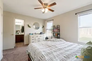 a bedroom with a bed and a large mirror