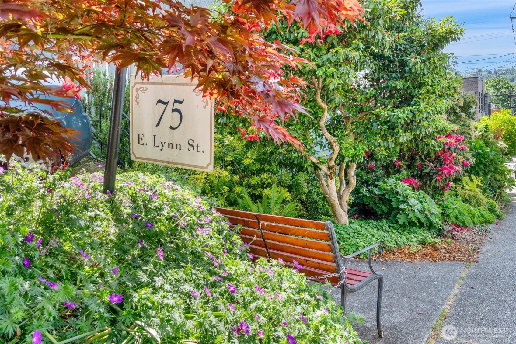 75 East Lynn Street, Unit B Seattle, WA 98102 - Photo 26 of 36 a sign that is sitting in a garden