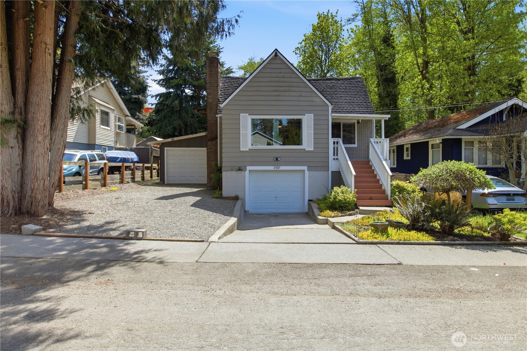2307 Southwest Myrtle Street Seattle, WA 98106 - Photo 2 of 30 a front view of a house with a yard and garage