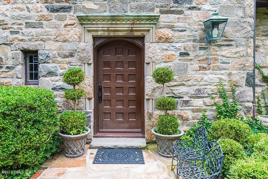 21 Konittekock Road Greenwich, CT 06831 - Photo 3 of 23 a front view of a house with potted plants