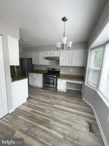 a view of kitchen and kitchen with a sink