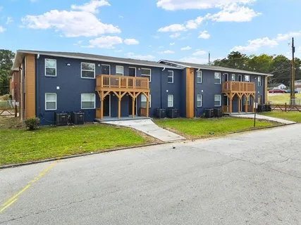 a view of a house with backyard and porch