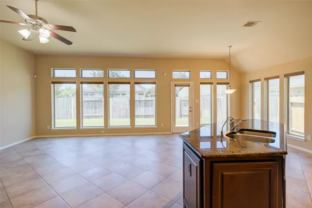 a view of room with a ceiling fan and a window