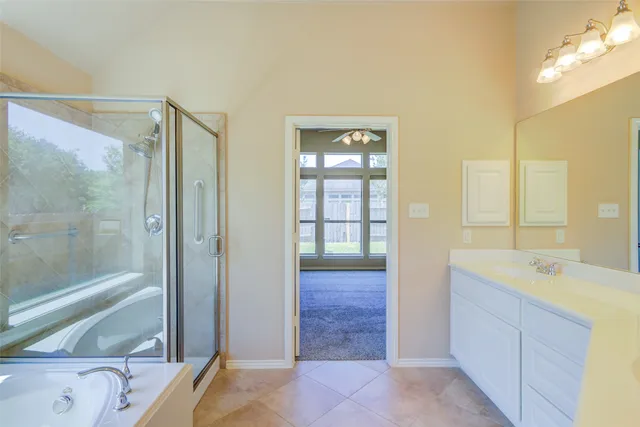 a bathroom with a granite countertop sink mirror and shower