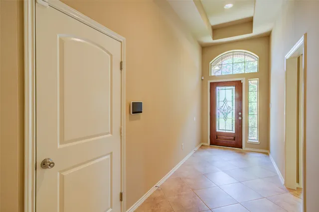 a view of a entryway door with a hallway