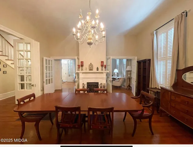 a view of a dining room with furniture and chandelier