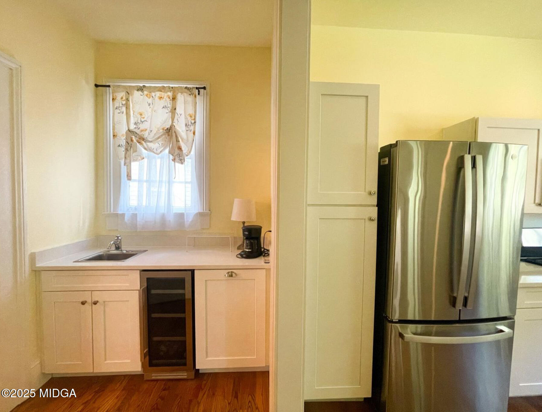 305 Orange Street Macon, GA 31201 - Photo 14 of 35 a kitchen with a refrigerator a sink and cabinets