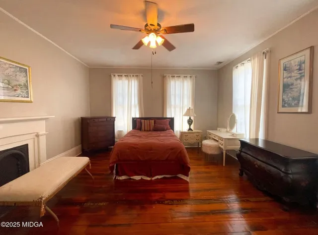 a living room with furniture fireplace and a window