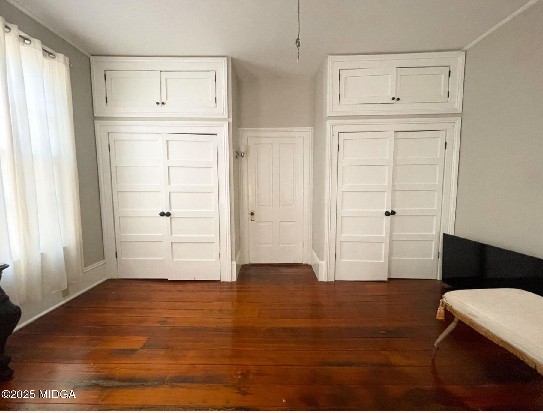 305 Orange Street Macon, GA 31201 - Photo 19 of 35 an empty room with wooden floor cabinet and windows