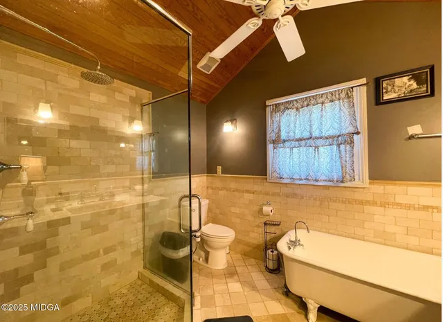 a bathroom with a bathtub and shower