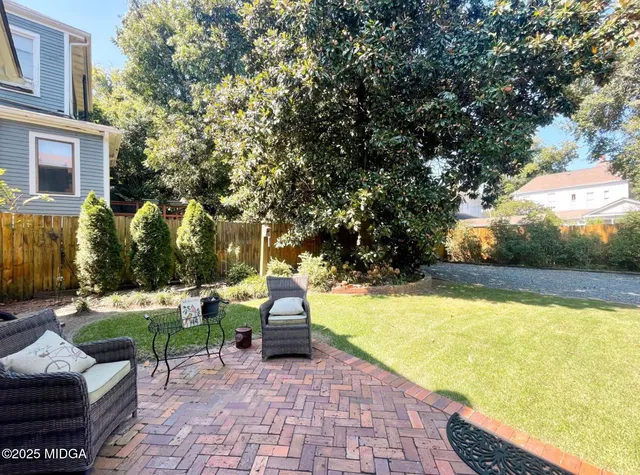 a view of backyard with swimming pool