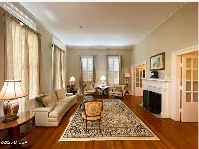 a living room with furniture windows and a fireplace