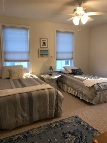 a bedroom with bed and a window