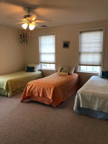 a bedroom with two beds and a window