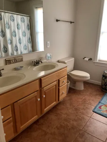 a bathroom with a toilet sink and mirror