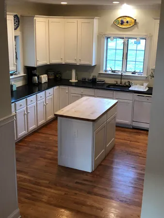 a kitchen with a stove a sink and a window