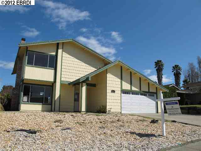 1047 Sandpoint Drive Rodeo, CA 94572 - Photo 1 of 1 a house with trees in front of it