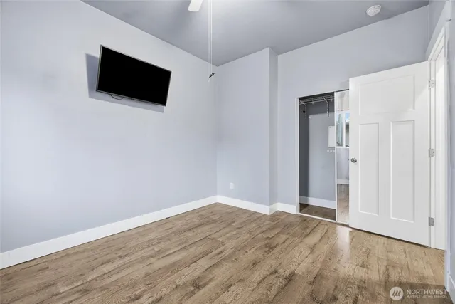 a view of a livingroom with wooden floor and a flat screen tv