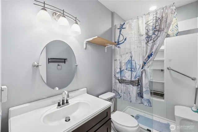 a bathroom with a sink toilet and shower