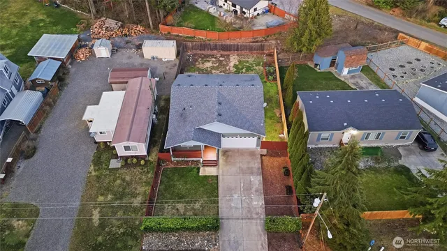 an aerial view of multiple houses with a yard