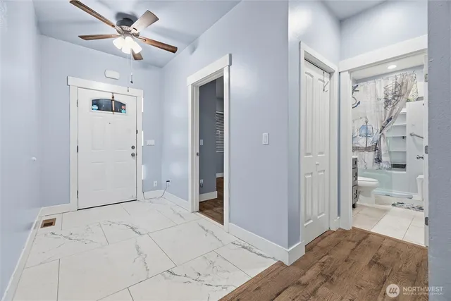 a spacious bedroom with a large bed and a chandelier