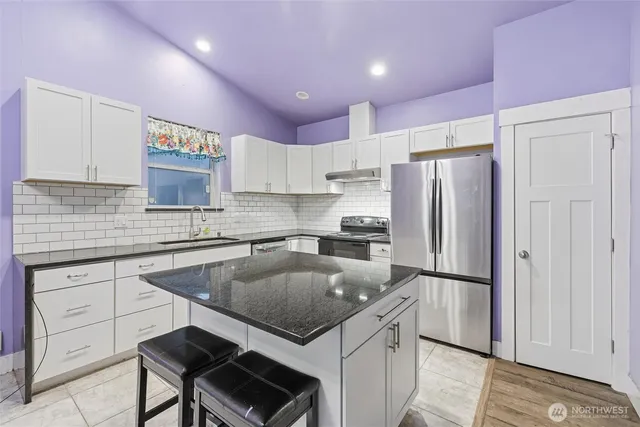 a kitchen with a refrigerator and a sink