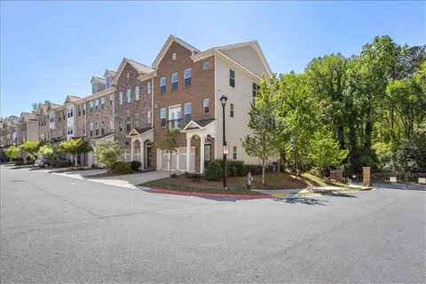 a view of a yard with a wooden fence